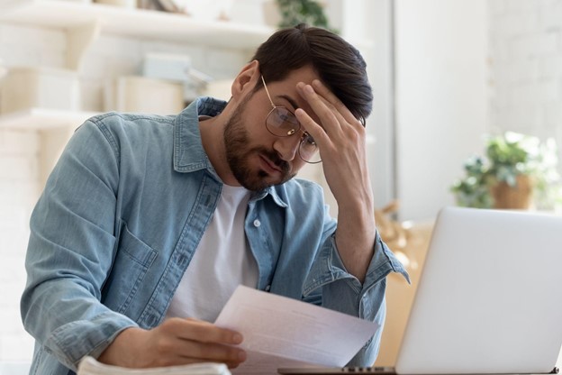 A Man Holding Denial Paperwork for Certificate of Good Standing